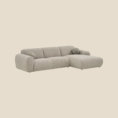 Grå modulsofa med chaiselong og lavt ryglæn - moderne komfort til stuen.
